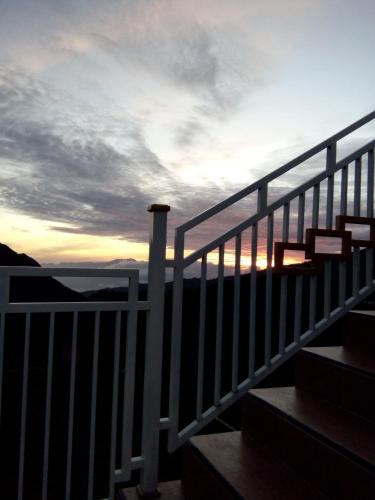 a stair case with a sunset in the background at Bromo Otix Guest House in Bromo
