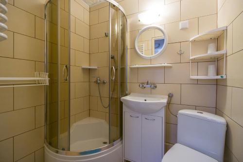 a bathroom with a shower and a toilet and a sink at Aura in Szklarska Poręba
