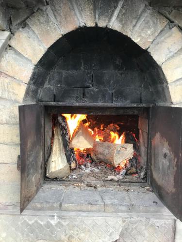 a large brick oven with fire in it at Villa Medova in Kosiv