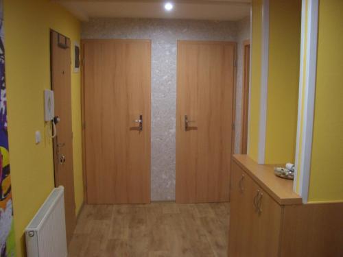 a hallway with two wooden doors in a room at Apartment Mikulov, Husova Ulice in Mikulov