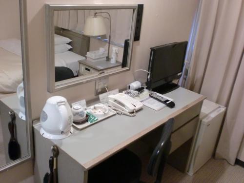 Postel nebo postele na pokoji v ubytování Tsuyama Central Hotel Annex