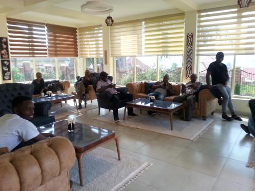 a group of people sitting in a living room at Ikaze B&B in Kigali