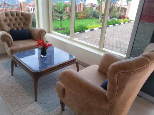 a living room with two chairs and a coffee table at Ikaze B&B in Kigali