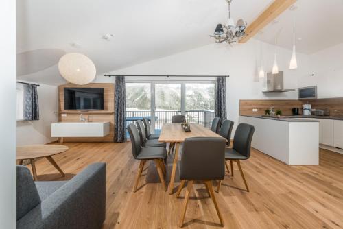 a dining room and kitchen with a table and chairs at Panorama Lodge Premium Apartments in Schladming