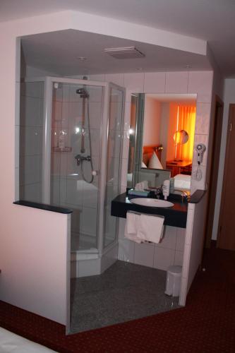 a bathroom with a shower and a sink at Hotel & Restaurant Zum Ochsen -Ox Distillery in Hösbach