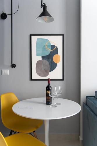 a dining room with a white table and yellow chairs at My Lodge Italy Centro Storico in Naples