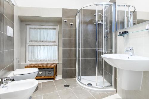 a bathroom with a shower and a toilet and a sink at My Lodge Italy Centro Storico in Naples