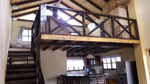 a loft bed in a room with a staircase at Cabañas de Bella Vista in Bella Vista