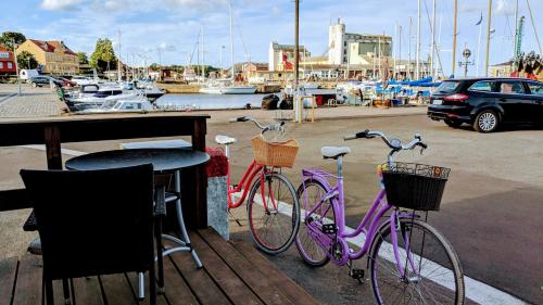 two bikes parked next to a table at a marina at Harbour Sleep in Neksø