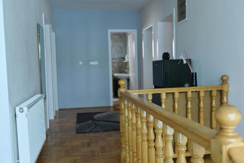 a hallway with a staircase with blue walls at Blue House Apartment in Niš