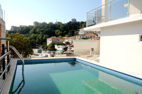 a swimming pool on the balcony of a building at Mala Plaza in Ulcinj