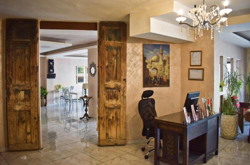a living room filled with furniture and a painting at Rafi Hotel in Amman