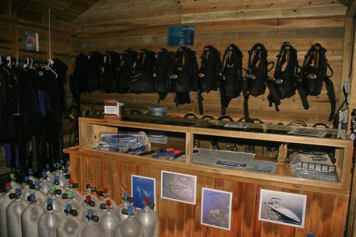 a room with a bunch of bags hanging on a wall at Las Rocas Resort and Dive Center in West Bay