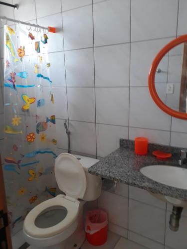 a bathroom with a toilet and a sink at Solar das Ostras Salinopólis in Salinópolis