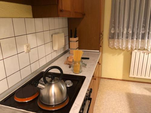 a tea kettle on a stove top in a kitchen at Apartment Gulek in Zreče