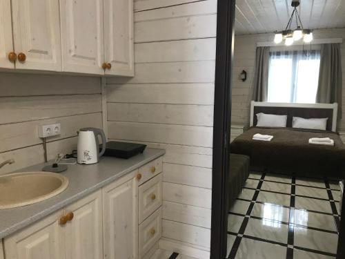 a small bathroom with a bed and a sink at Villa Medova in Kosiv