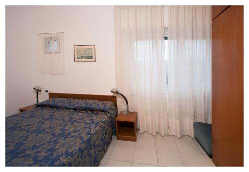 Ένα ή περισσότερα κρεβάτια σε δωμάτιο στο Casavacanze Internazionale