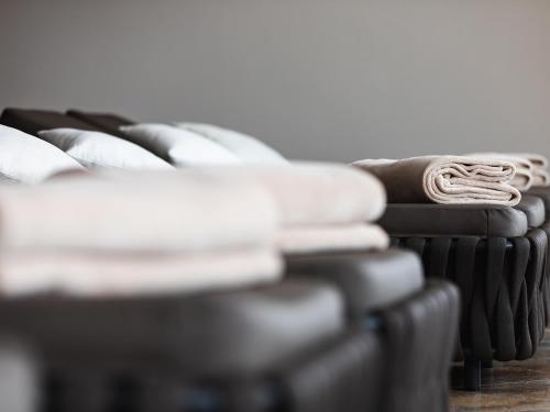 a pile of pillows sitting on top of a couch at Hotel Auszeit in Pertisau