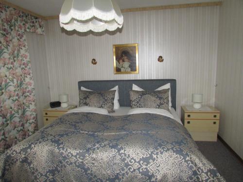 a bedroom with a large bed and two night stands at Ferienhaus Tschenett in Imst