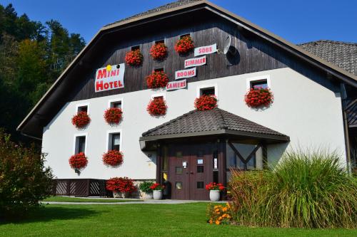 a barn with flower baskets on the side of it at Mini Hotel in Škofja Loka