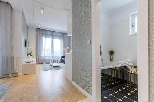 a room with a bathroom with a sink and a hallway at MM House in Zagreb