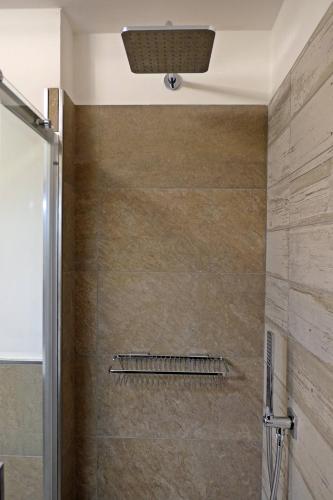 a bathroom with a shower with a glass door at Apartments Casa Metz in Santa Cristina Gherdëina