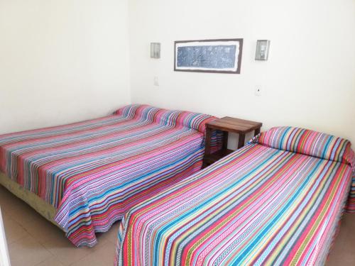 two beds sitting next to each other in a room at Parque Hotel in Santa Teresita