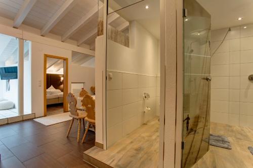 a bathroom with a shower and a glass door at Am Dorfplatz Suites - Adults only in Sankt Anton am Arlberg