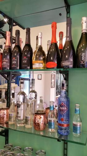 a shelf filled with lots of bottles of alcohol at Hotel Caravelle in Riccione