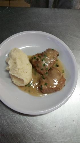 a plate of food with meat and ice cream on it at Hotel Caravelle in Riccione