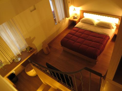 a bedroom with a bed and a table and a staircase at Mario's Garni in Pescocostanzo