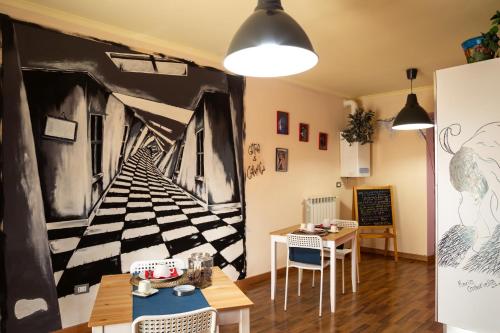 a dining room with a large painting on the wall at Camaga in LʼAquila