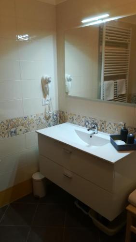 a bathroom with a sink and a mirror at Casabb in Toscolano Maderno