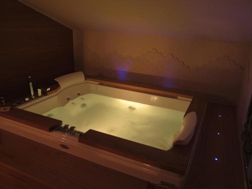 a bath tub in a bathroom with a map on the wall at Mario's Garni in Pescocostanzo