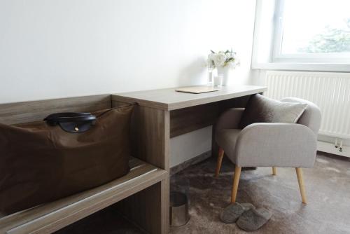 a desk and a chair in a room at Hotel La Chaumette in Privas
