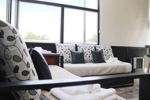 a living room with a couch and a window at Limay Bed&Breakfast in Neuquén