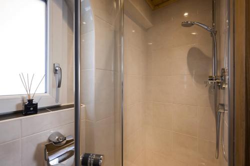 a shower with a glass door in a bathroom at Anja's Schönblick - Bed & Breakfast in Gerlos