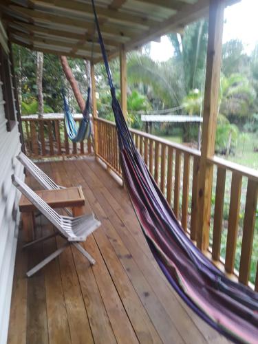 a porch with a hammock and a bench on it at Hidden Haven in Unitedville