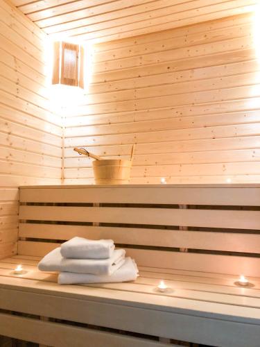 a bunch of towels sitting on a bench in a sauna at Wildwood Villa in Apriltsi