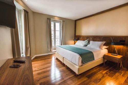 a bedroom with a bed and a television in it at Rossio Boutique Hotel in Lisbon