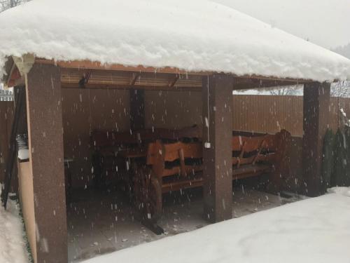 a snow coveredshed with snow on top of it at Shelest Vody in Russkaya Mokraya