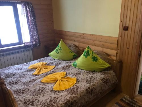 a bed with yellow bows on top of it at Shelest Vody in Russkaya Mokraya
