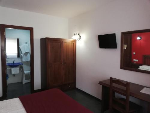 a bedroom with a bed and a mirror and a dresser at Casa Rural Casole in Castalla