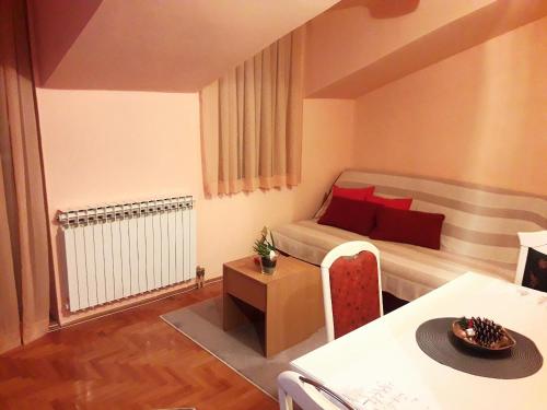 a small room with a bed and a table at Cozy Dream Apartment in Sarajevo