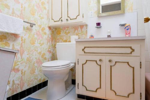 a bathroom with a white toilet and a sink at Hostel Style Shared Room in Daly City