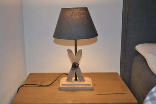 a table with a lamp on top of a table at Chalet Königsstand in Garmisch-Partenkirchen