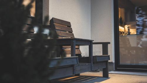 a wooden bench sitting in front of a building at Haus Schlager "dasAppartement" in Annaberg im Lammertal