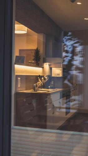 a kitchen with a sink and a stove at Haus Schlager "dasAppartement" in Annaberg im Lammertal