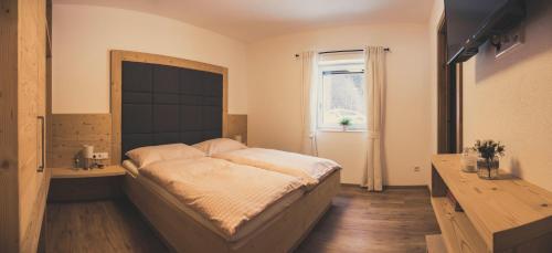 a bedroom with a large bed and a window at Haus Schlager "dasAppartement" in Annaberg im Lammertal
