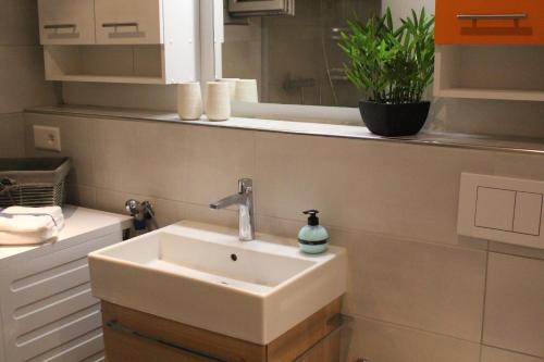 a white sink in a bathroom with a mirror at Haus Siegfried in Churwalden